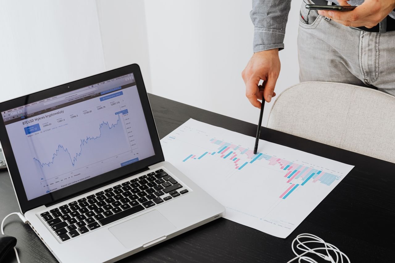 our-story Person analyzing cryptocurrency data using a laptop, highlighting financial insights.